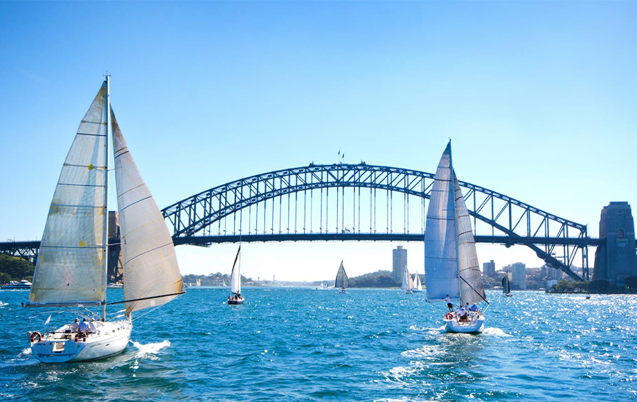 Boats sailing near Sydney Harbour Bridge