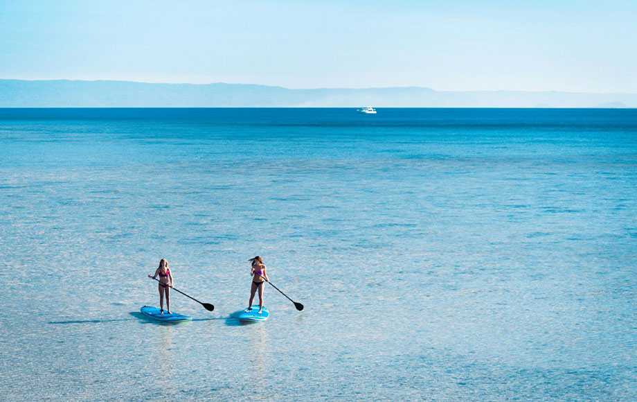 Orpheus Island Lodge paddle boarding in the waters of the Great Barrier Reef